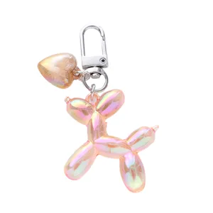 Charming iridescent pink balloon dog keychain with gold heart pendant for bag decoration