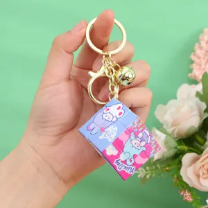 Close-up of mini cube keychain featuring cute pink cartoon rabbit and Nice Day text