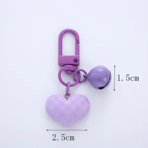 Close-up of purple heart keychain with bell showing 2.5cm and 1.5cm detail sizes.