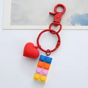 Detailed macro view of colorful plastic building blocks and red heart keychain charm