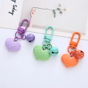 Close-up of colorful faceted heart keychains with matching bells and metal clasps