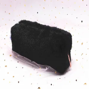 Close-up of soft black plush octagonal pencil bag with metallic zipper
