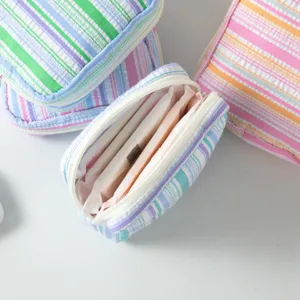 Portable colorful striped seersucker storage pouch for sanitary napkins and small cosmetics.