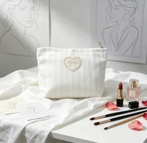 Minimalist white corduroy cosmetic bag featuring lace heart and bow embroidery detail