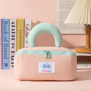 Chic pink and mint green pillow-style cosmetic bag displayed in a cozy room setting