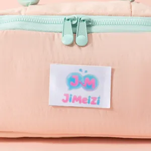 Close-up of the mint blue double zipper and brand logo on a peach quilted cosmetic bag