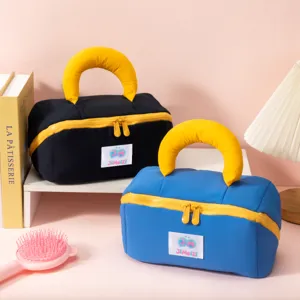 Two colorful padded travel makeup bags with soft marshmallow handles and dual zippers
