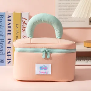 Close-up front view of peach pink and mint green travel makeup bag with soft handle
