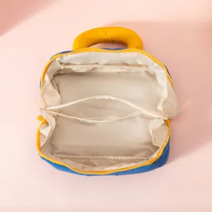 Detailed interior view of the blue and yellow makeup bag with storage compartments.