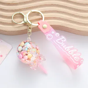 Detailed view of a cute pink lollipop liquid shaker keychain with colorful candy beads inside
