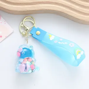Close-up detail of a light blue unicorn keychain featuring colorful oil floating beads.