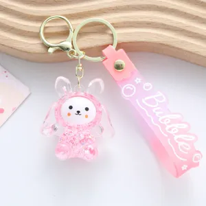 Close-up view of pink acrylic bunny keychain with sparkling liquid shaker detail
