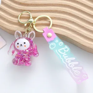 Detail of a purple acrylic rabbit keychain with stars quicksand and a Bubble strap.