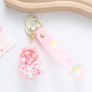 Detailed view of a cute pink unicorn oil-filled floating bottle keychain with a rainbow strap