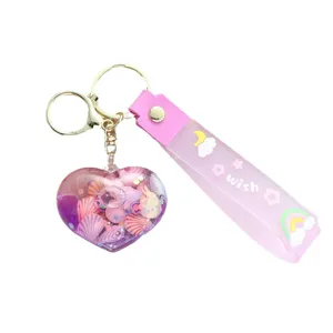 Creative heart-shaped liquid quicksand keychain with pink silicone strap and shells