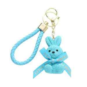 Adorable light blue resin rabbit keychain with knitted texture and braided wrist strap