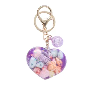 Creative heart-shaped quicksand keychain featuring colorful seashells and purple glitter beads