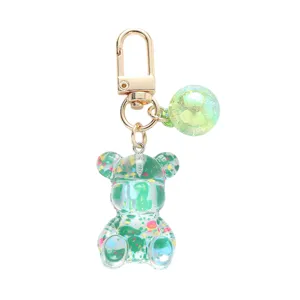 Cute acrylic bear keychain with colorful splatter paint and iridescent ball charm.