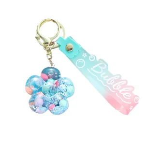 Charming flower-shaped liquid sand shaker keychain with blue and pink gradient strap