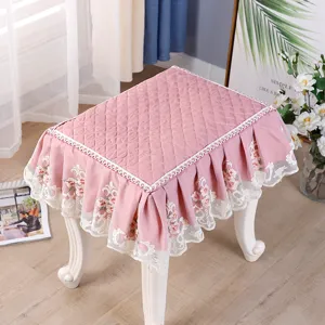 Pink quilted square stool cover with white lace ruffles, elegant vanity bench slipcover detail.