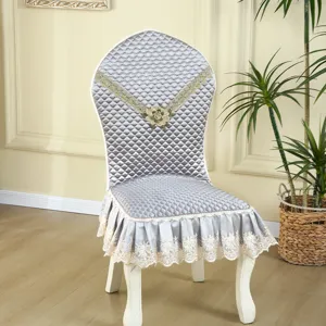European style quilted dining chair cover with elegant gold embroidery and ruffled skirt for home decor.