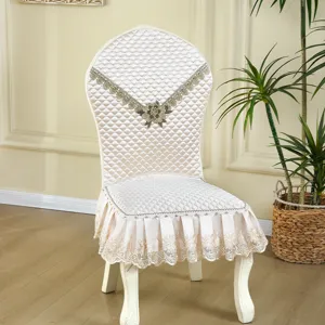 European quilted dining chair cover with elegant lace skirt and floral embroidery.
