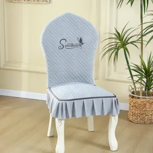 Close-up detail of the gray quilted dining chair cover featuring a sweethearts embroidery.