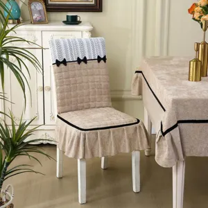 Detail view of the elegant all-inclusive dining chair cover with matching tablecloth set.