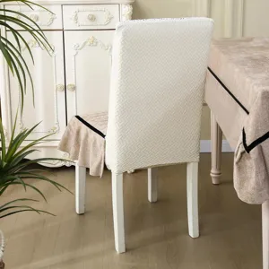Detailed view of jacquard dining chair cover with elegant ruffle trim and black contrast edge.