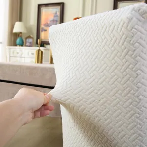 Elastic stretch detail of jacquard chair slipcover, showing soft woven fabric texture.
