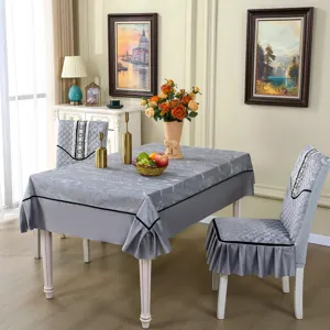 Elegant gray quilted chair covers and matching tablecloth in a formal dining room
