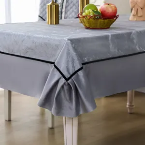Macro view of a grey marble textured tablecloth with black trim and elegant pleated corner
