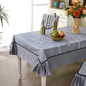 Detailed view of elegant grey marble pattern tablecloth and matching quilted chair covers