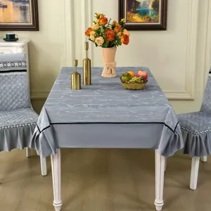 Élégante nappe marbrée grise et housses de chaise matelassées assorties dans une salle à manger.