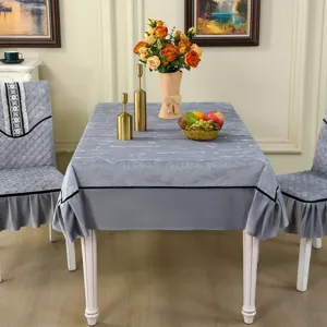 Elegant grey marble pattern tablecloth with matching ruffled chair covers in a dining room