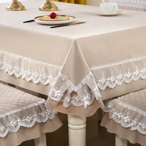 Macro view of beige velvet dining tablecloth and chair covers featuring delicate white lace trim