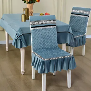 Gros plan sur les housses de chaise en velours bleu avec dentelle et motifs matelassés.