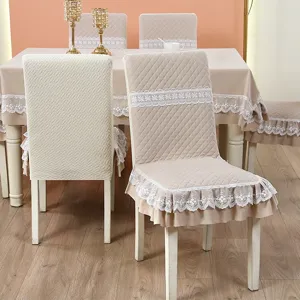 Detailed view of quilted chair covers with elegant white lace trim and ruffles.