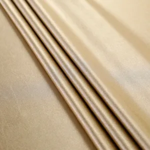 Detail shot of champagne gold satin fabric showing elegant folds and smooth sheen