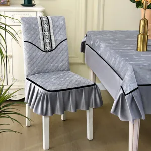Detail of gray quilted chair cover with lace trim and matching tablecloth set
