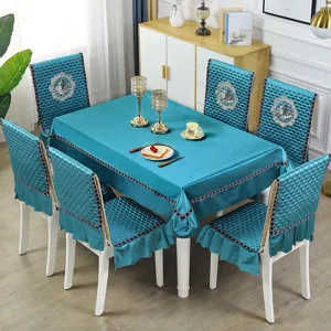 Detailed macro view of the turquoise quilted tablecloth and matching chair cover set
