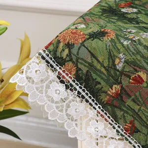 Detailed shot of retro botanical tablecloth with white lace trim, elegant dust cover.