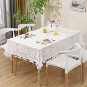 French vintage lace tablecloth detail, elegant hollow-out design with delicate tassels.