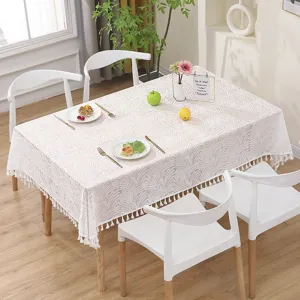 Detailed view of french retro lace tablecloth with tassel edge in elegant cream finish.