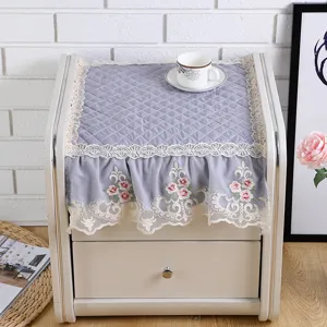Detailed view of the quilted bedside cabinet dust cover with elegant lace and floral embroidery.