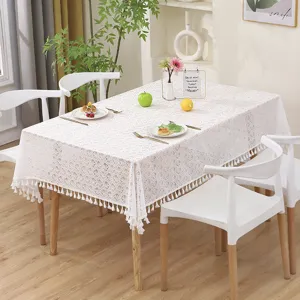 White lace tablecloth with fringe, hollow leaf design, elegant table cover for home dining decor.