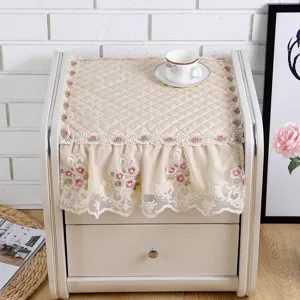 Quilted bedside table dust cover with elegant lace trim, multi-functional fabric decor.