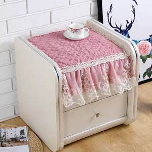 Quilted pink bedside table dust cover with elegant lace embroidery for home bedroom decor style.