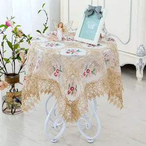 Detailed view of European style lace embroidered round tablecloth, elegant floral design decor.
