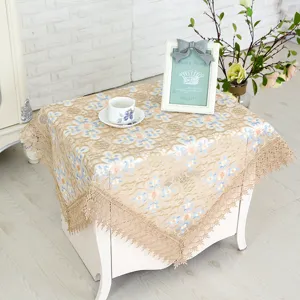 Elegant floral lace tablecloth and decorative dust cover for coffee table or nightstand decor.